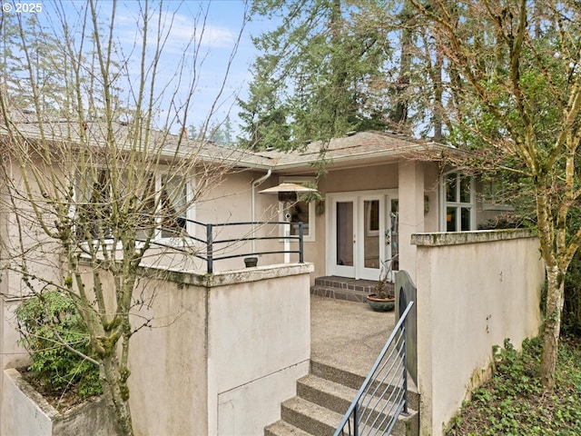 view of exterior entry featuring french doors