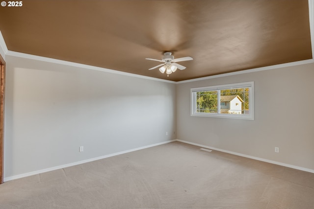 carpeted spare room with ornamental molding and ceiling fan