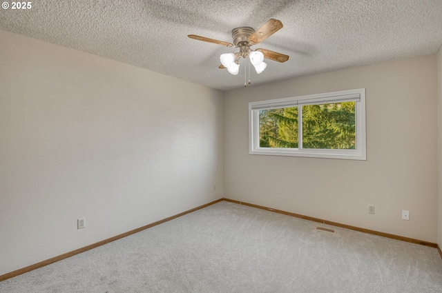 carpeted spare room with ceiling fan and a textured ceiling