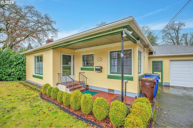 single story home with a garage and a front yard