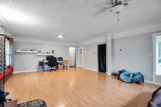 office area featuring ceiling fan, plenty of natural light, hardwood / wood-style floors, and a textured ceiling