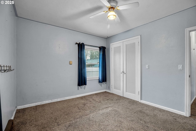 unfurnished bedroom featuring french doors, carpet flooring, ceiling fan, and a closet