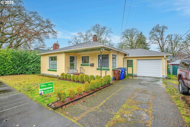 single story home with a garage and a front lawn