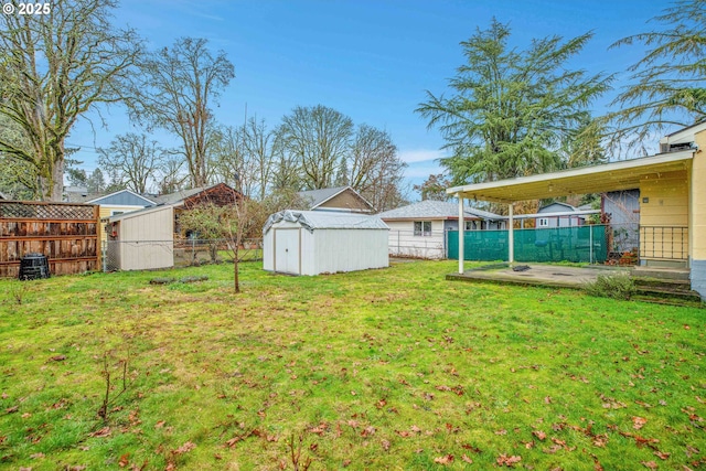 view of yard featuring a storage shed and a patio area