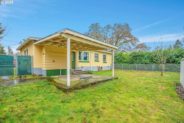 back of house with a patio and a lawn