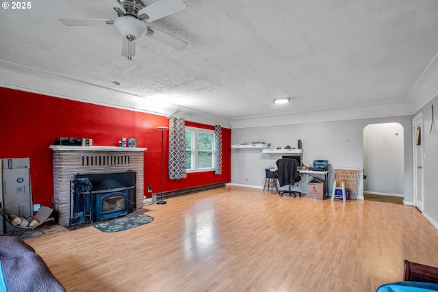 office with ceiling fan, hardwood / wood-style floors, a textured ceiling, and a baseboard heating unit