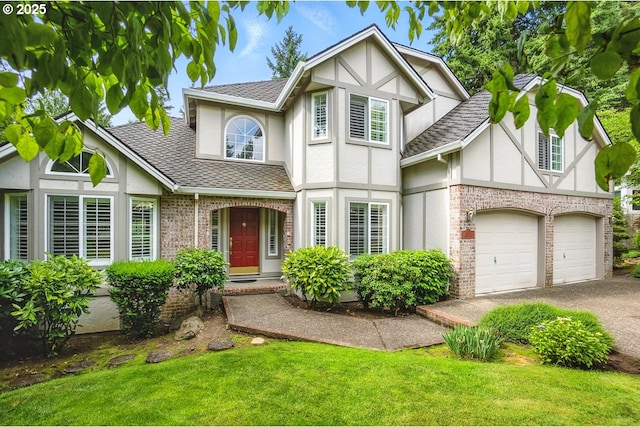 16081 SW Waxwing Pl, Beaverton, OR 97007 - english style home featuring stucco siding, roof with shingles, asphalt driveway, a front lawn, and brick siding