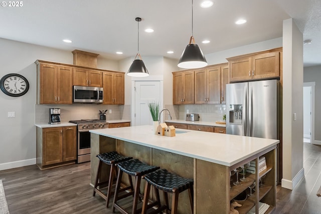 3466 N Holladay St, Cornelius, OR 97124 - kitchen featuring stainless steel appliances, decorative backsplash, light countertops, dark wood-type flooring, and recessed lighting