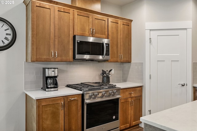 3466 N Holladay St, Cornelius, OR 97124 - kitchen with stainless steel appliances, brown cabinetry, and decorative backsplash