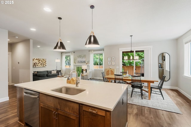 3466 N Holladay St, Cornelius, OR 97124 - kitchen with open floor plan, dark wood finished floors, light countertops, an island with sink, and decorative light fixtures