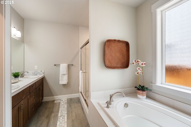 3466 N Holladay St, Cornelius, OR 97124 - full bathroom with double vanity, a bath, wood finished floors, and a stall shower