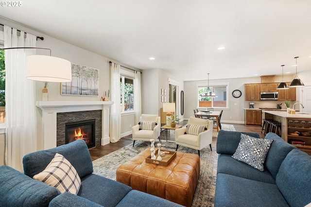 3466 N Holladay St, Cornelius, OR 97124 - living room with dark wood finished floors, a stone fireplace, and recessed lighting