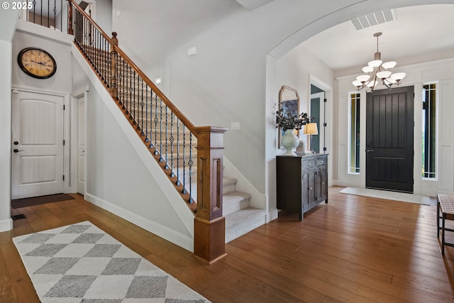 3534 NW Maple St, Camas, WA 98607 - foyer entrance featuring wood-type flooring, arched walkways, baseboards, a chandelier, and stairway