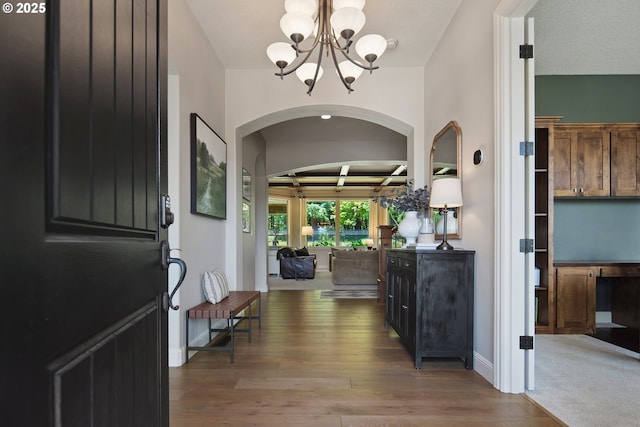 3534 NW Maple St, Camas, WA 98607 - foyer entrance featuring a chandelier, arched walkways, and wood finished floors