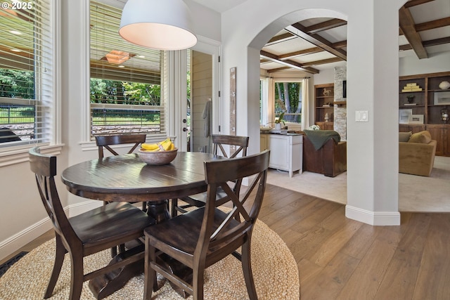 3534 NW Maple St, Camas, WA 98607 - dining area with coffered ceiling, arched walkways, beam ceiling, hardwood / wood-style floors, and healthy amount of natural light