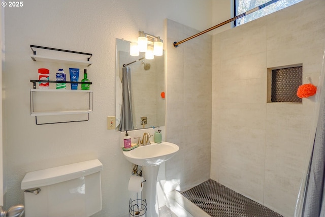 bathroom featuring toilet and a shower with shower curtain