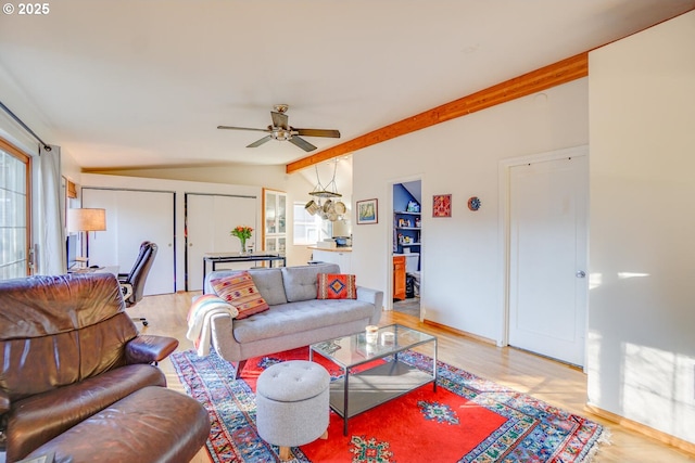 living room featuring hardwood / wood-style flooring, ceiling fan, and vaulted ceiling