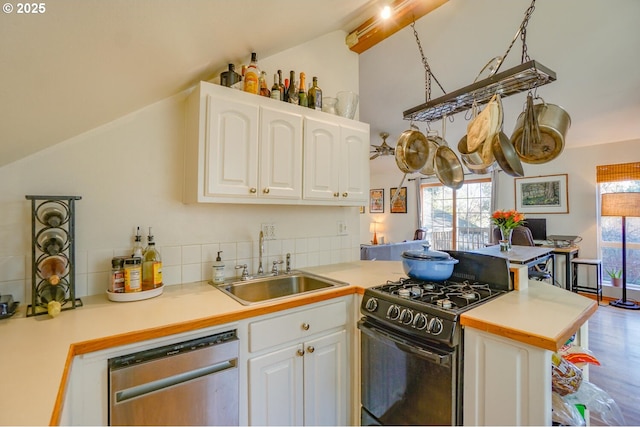 kitchen featuring stainless steel dishwasher, black range with gas stovetop, sink, and white cabinets