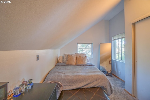 carpeted bedroom with vaulted ceiling