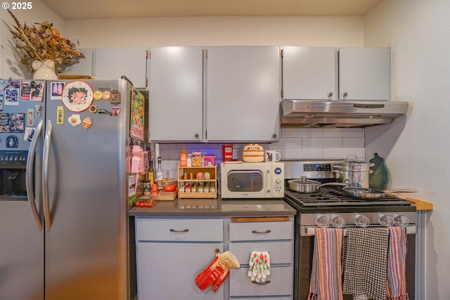 kitchen with stainless steel appliances and decorative backsplash