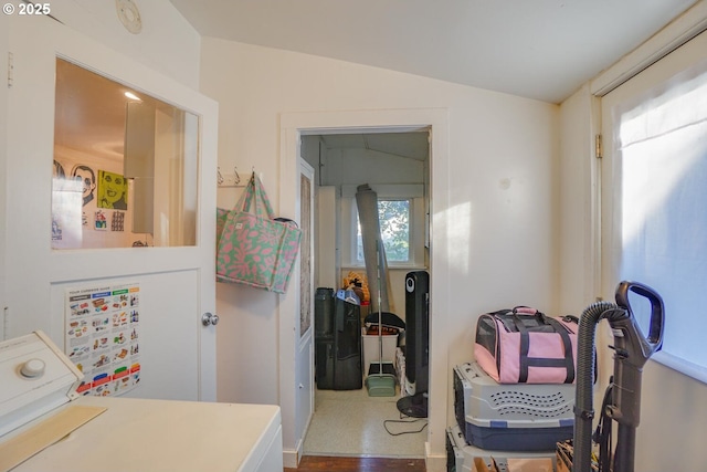 interior space featuring lofted ceiling, plenty of natural light, and washer / clothes dryer