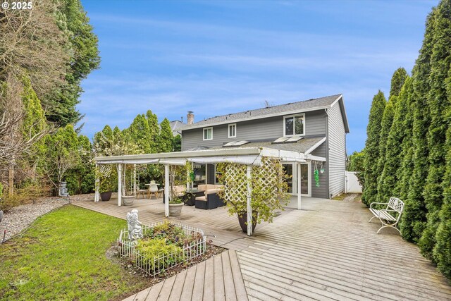 rear view of house featuring an outdoor hangout area, a wooden deck, a chimney, roof with shingles, and a yard