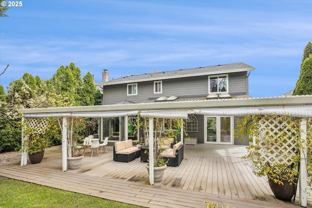 rear view of house featuring outdoor lounge area, a wooden deck, outdoor dining area, and french doors
