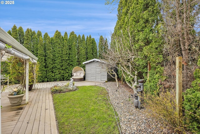 view of yard with an outbuilding, a storage shed, and a deck