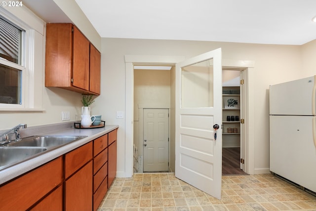 kitchen with sink and white fridge