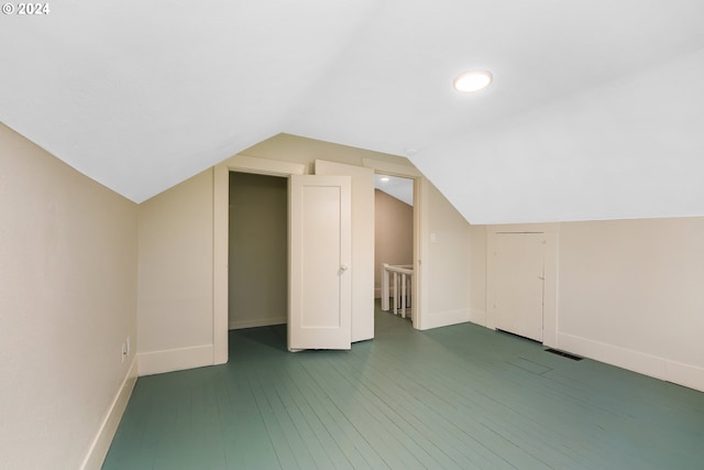 additional living space featuring lofted ceiling