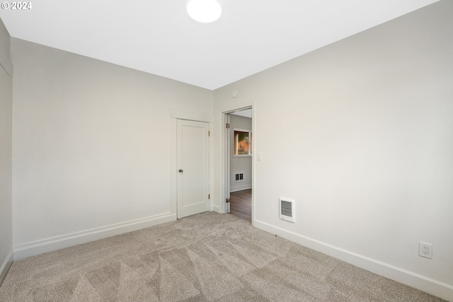 empty room featuring light colored carpet