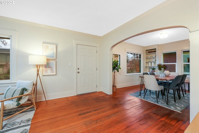 foyer entrance featuring crown molding and dark hardwood / wood-style flooring