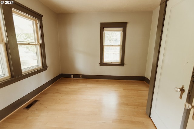 dining room with high vaulted ceiling, a wood stove, light wood-style floors, and baseboards