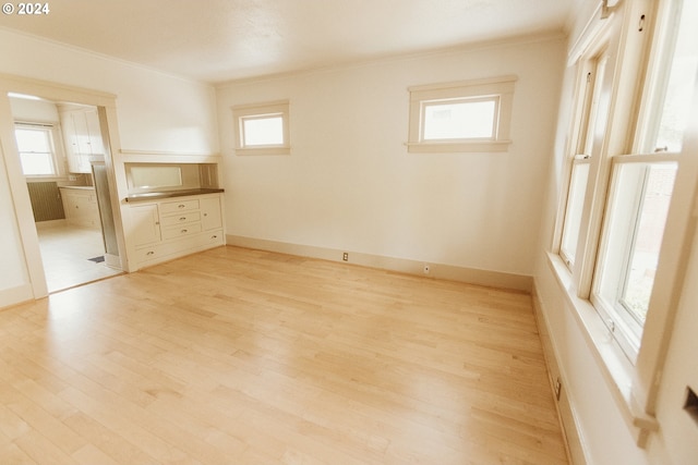 living room with light wood-style flooring, high vaulted ceiling, and a skylight