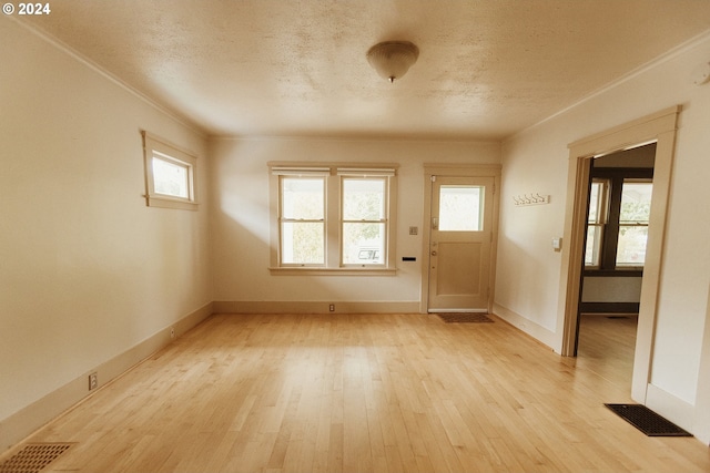 living room featuring a wood stove, high vaulted ceiling, wood finished floors, and a healthy amount of sunlight
