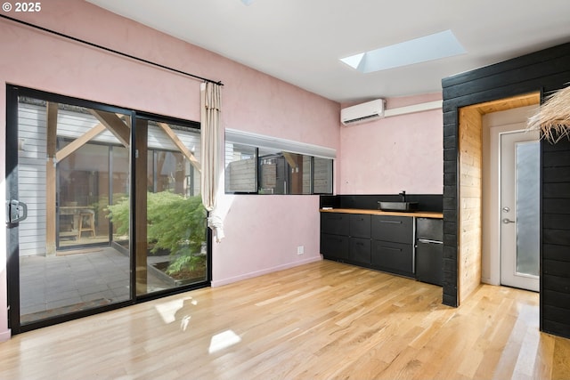 spare room featuring light wood-style flooring and baseboards