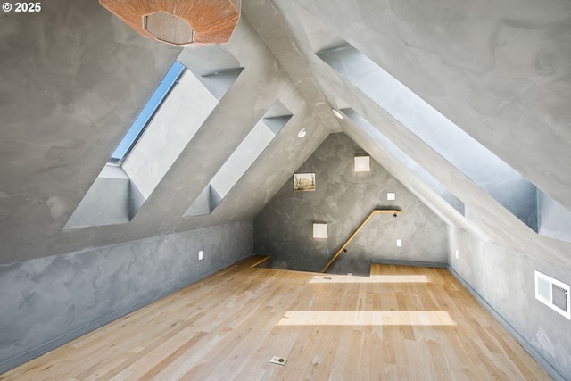 spare room with ornamental molding, visible vents, and light wood-style floors