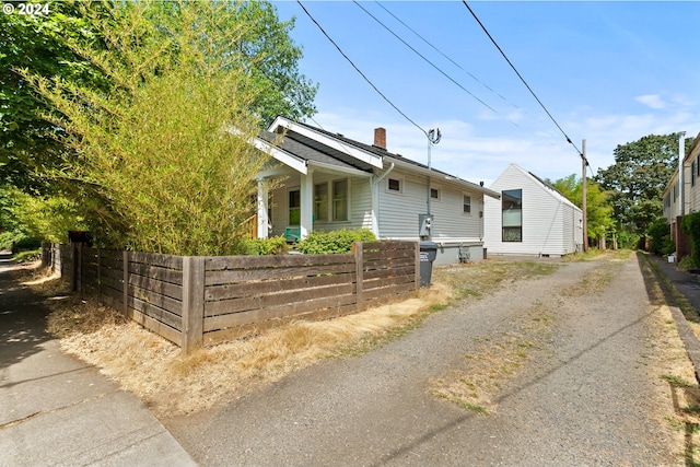 view of front of property with a chimney and a fenced front yard