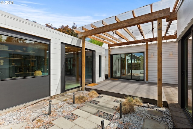 interior space with dark tile patterned floors, access to exterior, multiple windows, and expansive windows