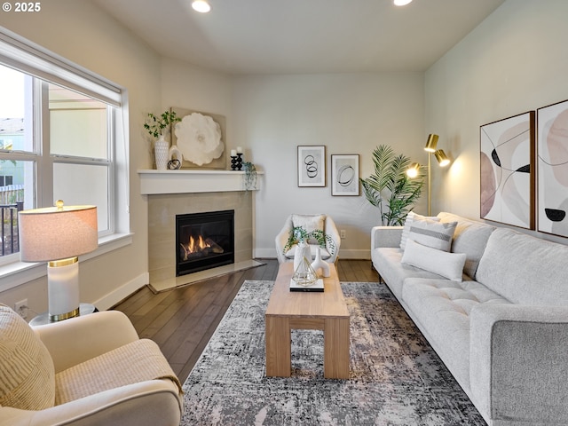 living room featuring baseboards, hardwood / wood-style flooring, and recessed lighting