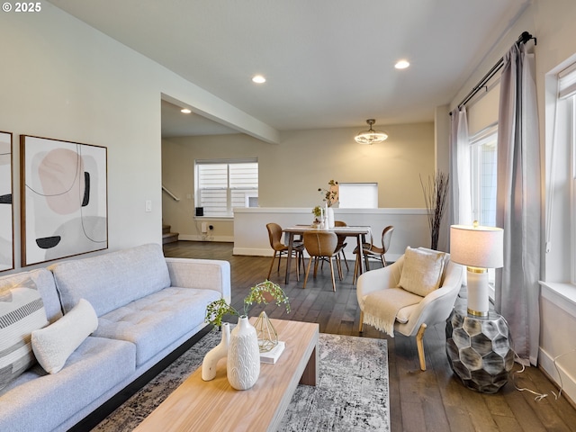 living area featuring baseboards, stairway, hardwood / wood-style floors, and recessed lighting