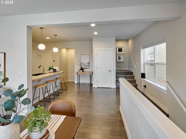 living area featuring baseboards, dark wood-style flooring, stairway, and recessed lighting