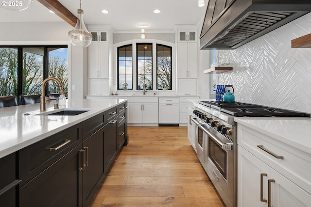 14014 NW 57th Ave, Vancouver, WA 98685 - kitchen with white cabinetry, light countertops, double oven range, a sink, and wall chimney exhaust hood