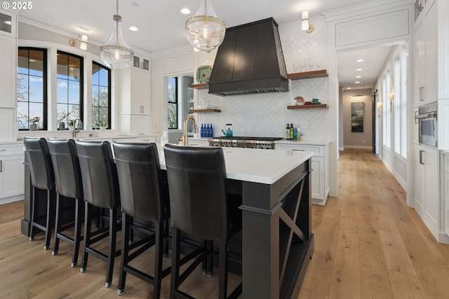 14014 NW 57th Ave, Vancouver, WA 98685 - kitchen featuring light countertops, custom exhaust hood, appliances with stainless steel finishes, and open shelves