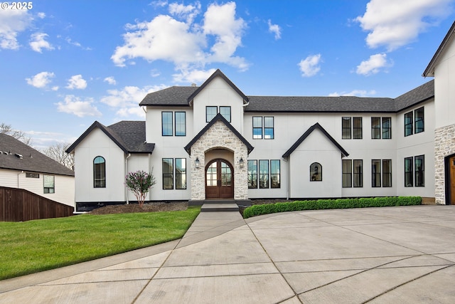 14014 NW 57th Ave, Vancouver, WA 98685 - view of front of property with stone siding, french doors, roof with shingles, stucco siding, and a front lawn