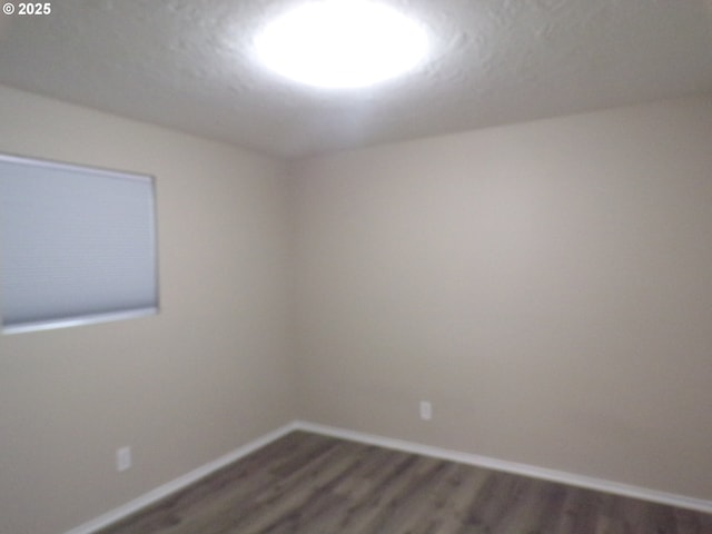 870 W Lincoln St, Woodburn, OR 97071 - spare room with dark wood-type flooring and baseboards