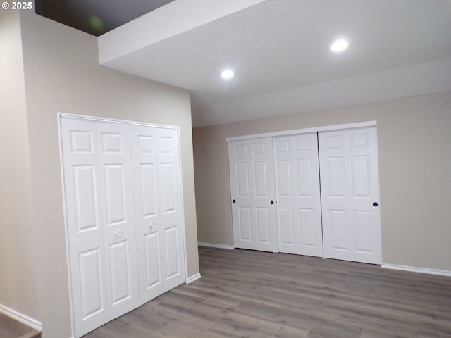 870 W Lincoln St, Woodburn, OR 97071 - unfurnished bedroom featuring baseboards, recessed lighting, and wood finished floors