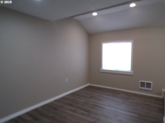 870 W Lincoln St, Woodburn, OR 97071 - spare room featuring dark wood-style flooring, baseboards, visible vents, and lofted ceiling