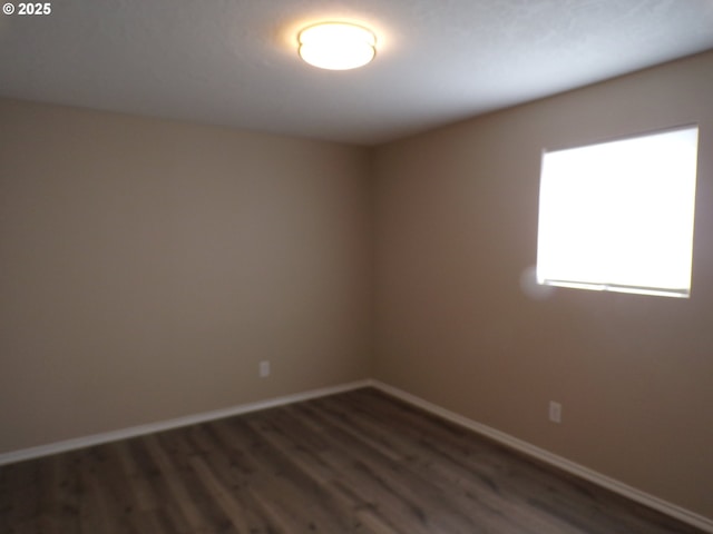 870 W Lincoln St, Woodburn, OR 97071 - empty room featuring baseboards and dark wood finished floors