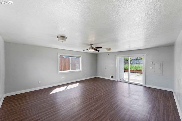unfurnished room with ceiling fan, a textured ceiling, and dark wood-type flooring